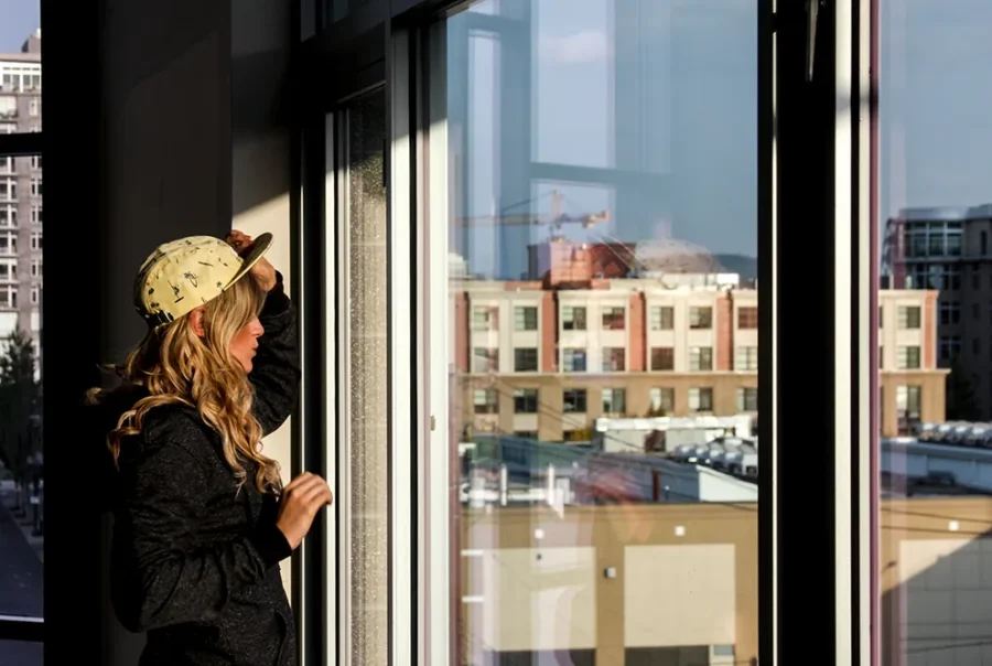 woman wearing custom camp hat in outdoor urban setting with natural light