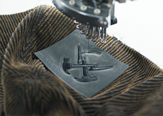 Machine embroidered logo on the front page