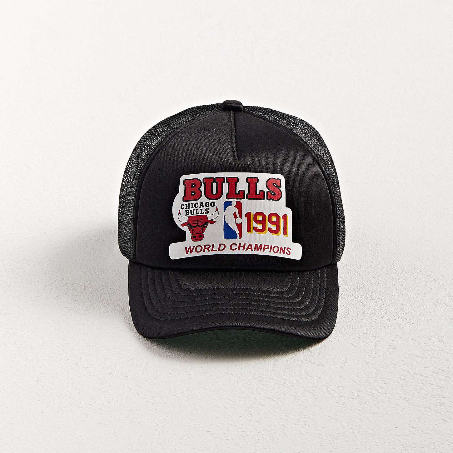 Front view of Chicago Bulls Champions Trucker Hat with vibrant vintage-inspired screen print and foam front panel.