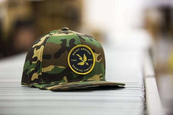 Camouflage snapback hat with yellow border woven patch "SAINT ARCHER BREWING COMPANY", custom headwear