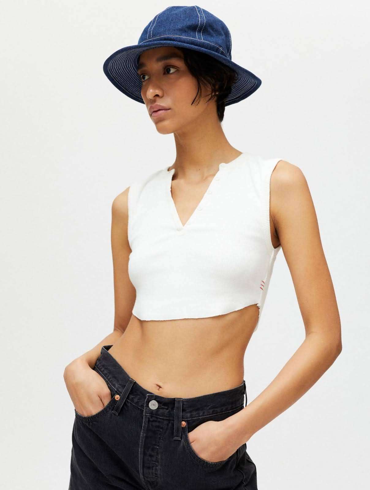 Dark blue structured denim bucket hat with white contrast topstitching, worn with casual denim outfit