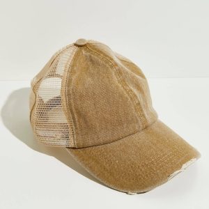 Front profile of a distressed structured cotton trucker hat featuring machine-frayed brim details and stone-washed color fading.