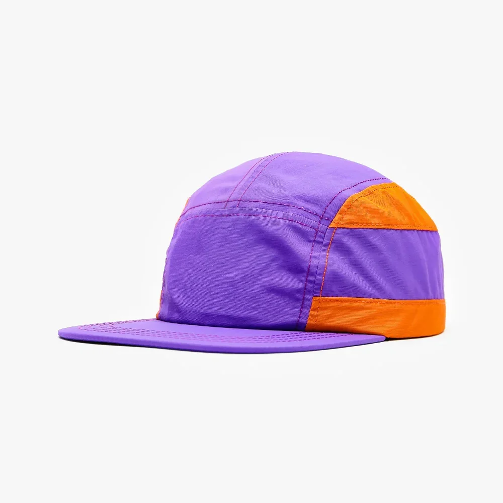 Side profile view of a lightweight purple and orange colorblock nylon 5-panel camp cap with a flat brim and contrasting stitch details.
