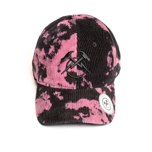 Direct front view of a pink and black tie-dye corduroy unstructured dad hat displaying centered tonal black flat embroidery across the front seam, a circular white branded sticker on the pre-curved brim, and soft low-profile crown structure.